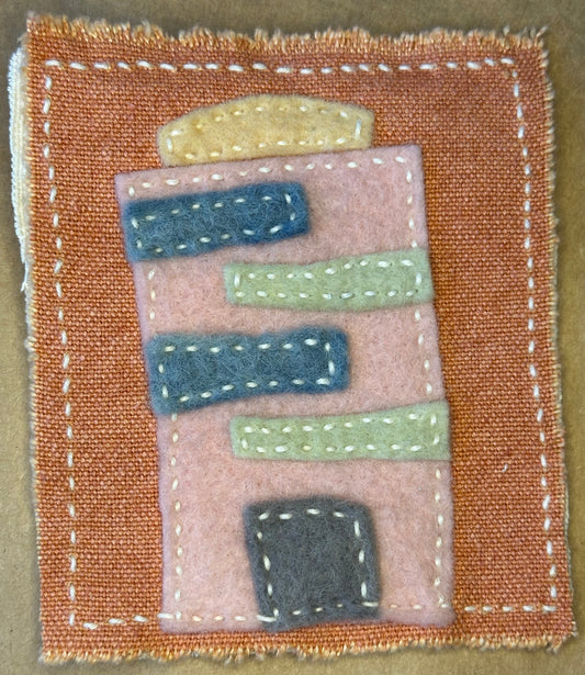 Textile artwork by Suzanne Gibbs from her Fragments of Home series, featuring colorful stitched rectangles on a cinnamon-colored fabric background.