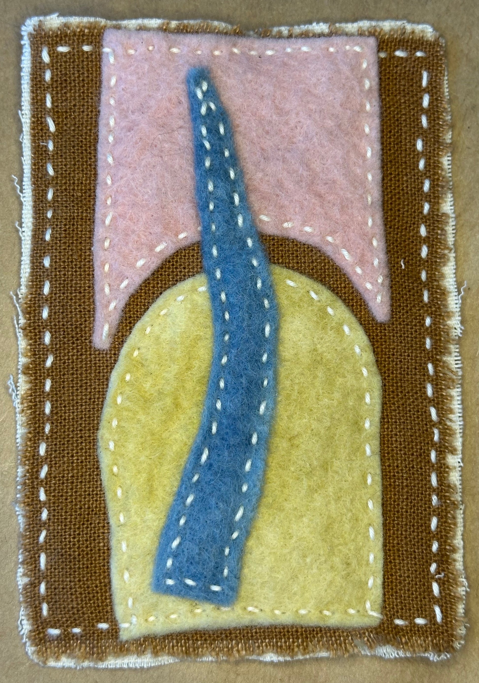 Textile art piece by Suzanne Gibbs of Portland Oregon representing a blue road traveling from yellow to pink, and back.