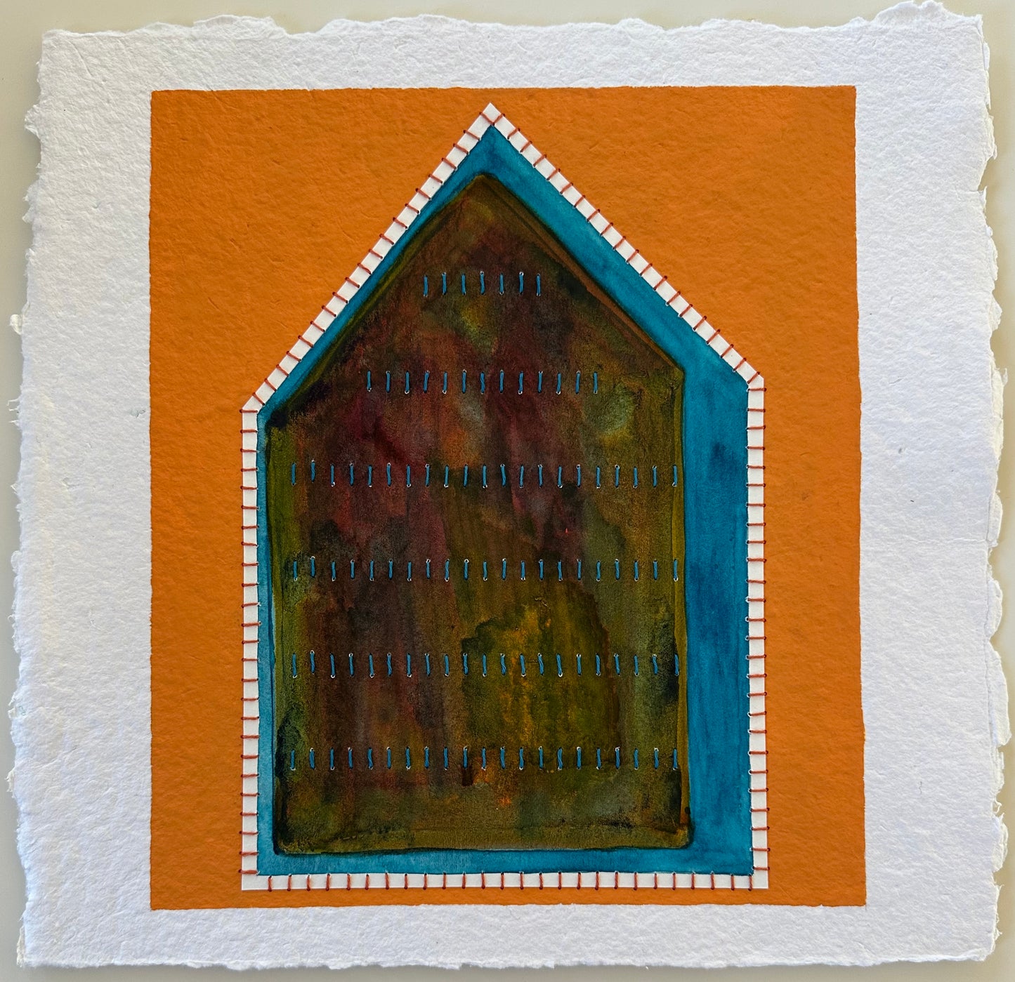 Fragments of Home #37, Difficult Space by Suzanne Gibbs. A house-shaped form in layered watercolor framed by teal and white stitched borders, set against a bold orange background.