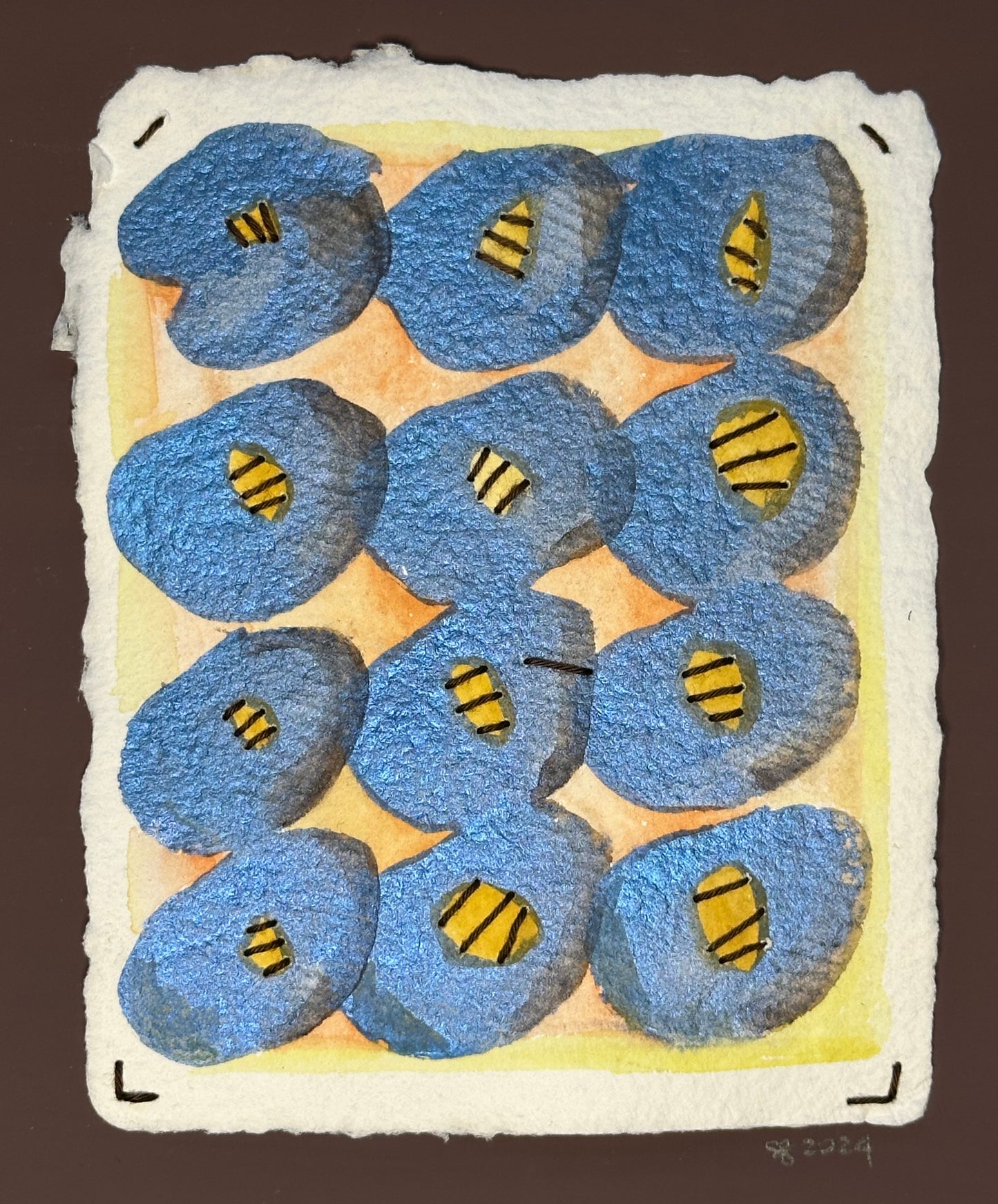 A small watercolor painting featuring geometric patterns with blue, brown, and orange colors made by Suzanne Gibbs.