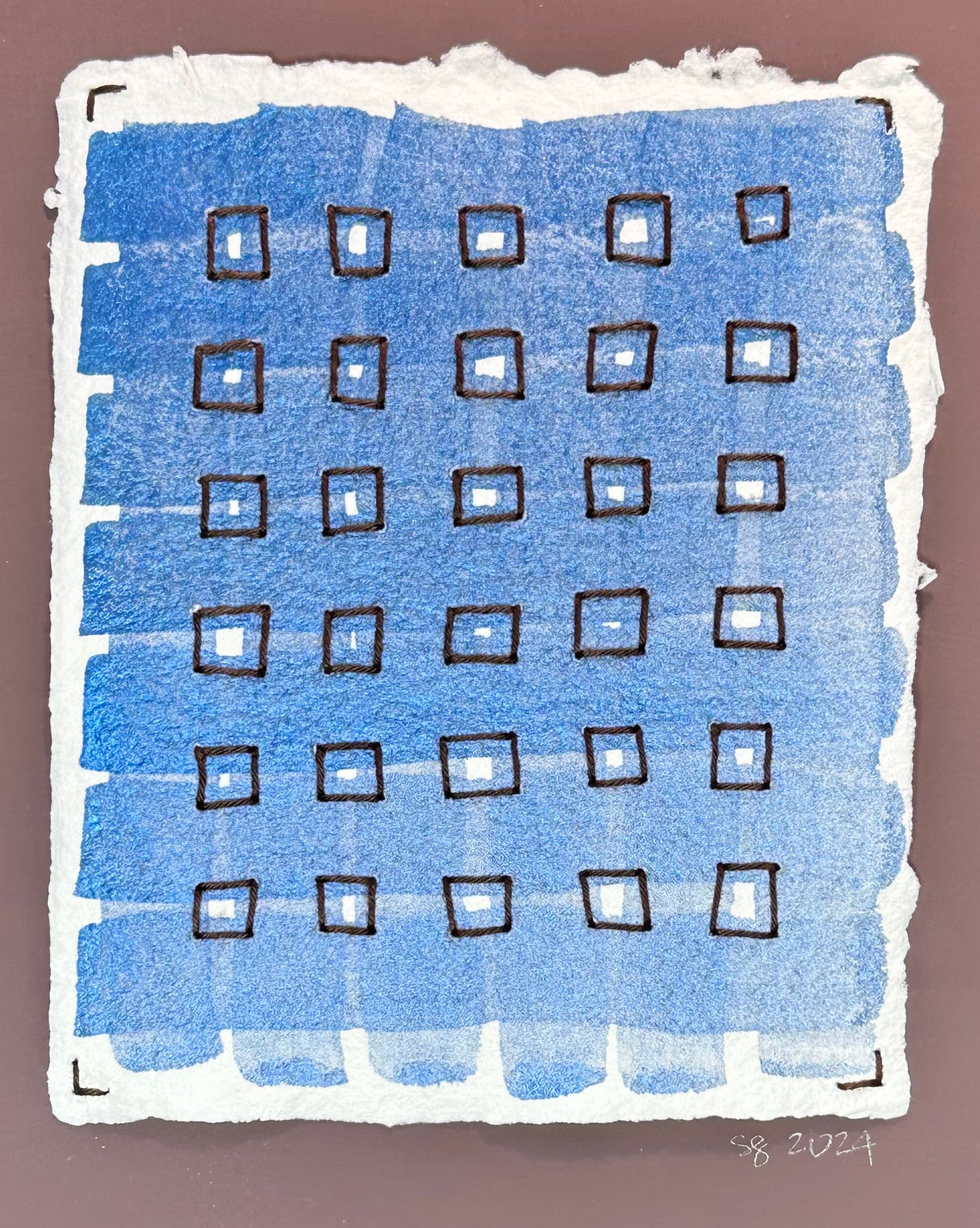 Mixed media artwork by Suzanne Gibbs from her Stitch & So series, created with watercolor paint and thread on handmade paper, featuring a plaid blue grid with brown stitched boxes.