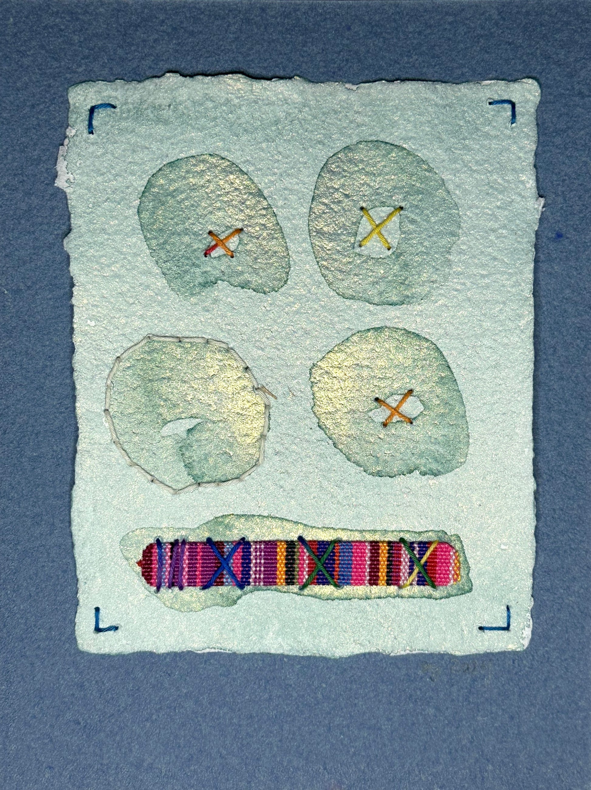 A watercolor and sashiko thread painting on handcrafted paper by Suzanne Gibbs, featuring a collage with Peruvian-inspired elements, signed and dated by the artist.