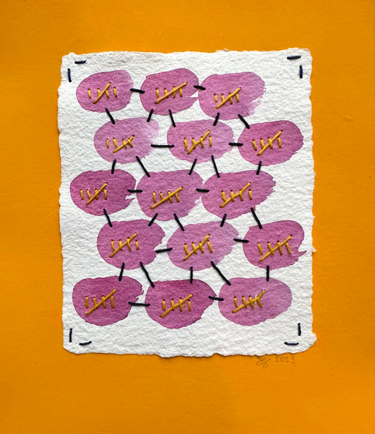 A piece of art made by Suzanne Gibbs with a white background featuring a grid of pink ovals and sashiko-style stitching with gold accents, presented on an orange background.
