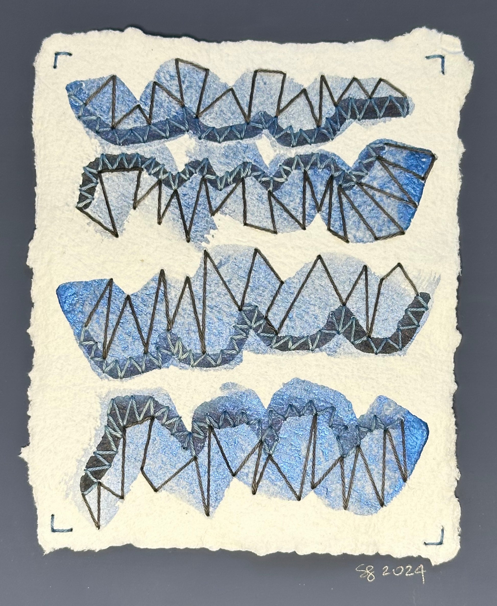 Mixed media artwork by Suzanne Gibbs from her Stitch & So series, created with watercolor paint and thread on handmade paper, featuring formations that resemble diamonds on a white background.