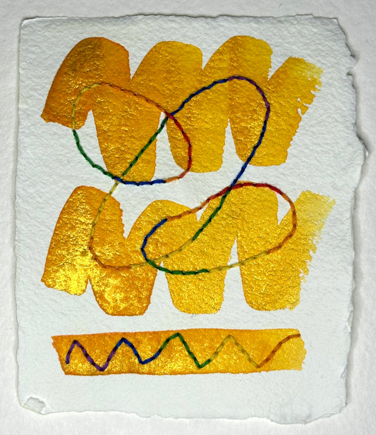 Abstract art made by Suzanne Gibbs with golden watercolor zig-zags and multi-colored variegated Sashiko thread on white handcrafted paper.