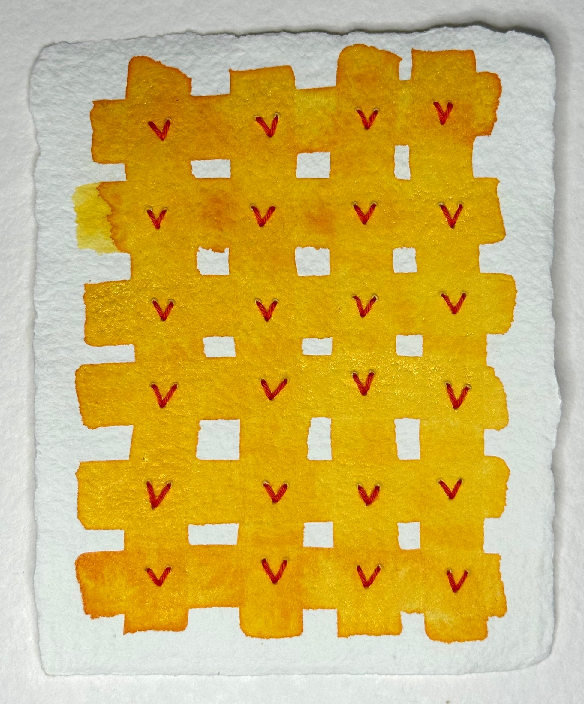 A watercolor, Sashiko thread on paper collage painting by Suzanne Gibbs featuring a 'V' grid design with yellow and orange colors on hand-crafted paper.