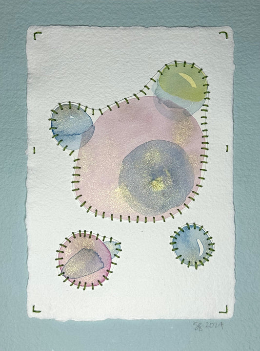 A watercolor, sashiko thread art piece on paper with a minimalist abstract design in muted pinks and blues, signed and dated by the artist, Suzanne Gibbs on the front.