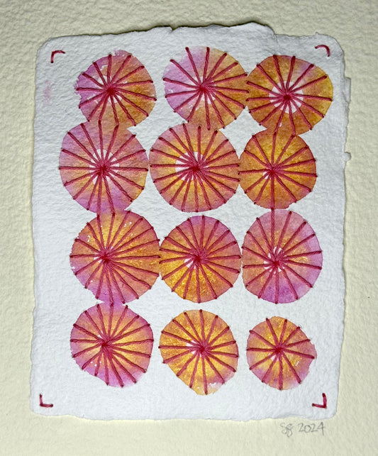 A miniature watercolor painting by Suzanne Gibbs that resembles twelve pink and orange umbrellas from above, each umbrella has hand-stitched ribs.